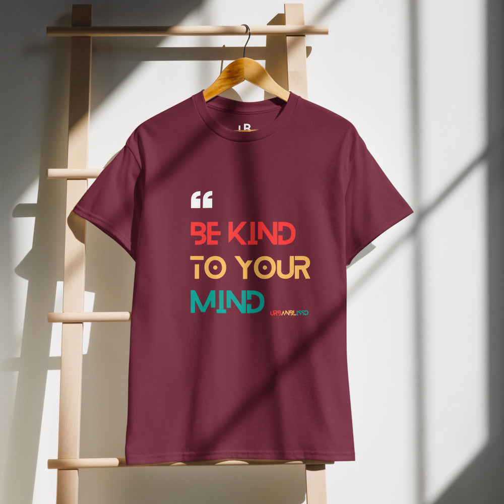 Maroon t-shirt with motivational quote on a wooden hanger against a white wall